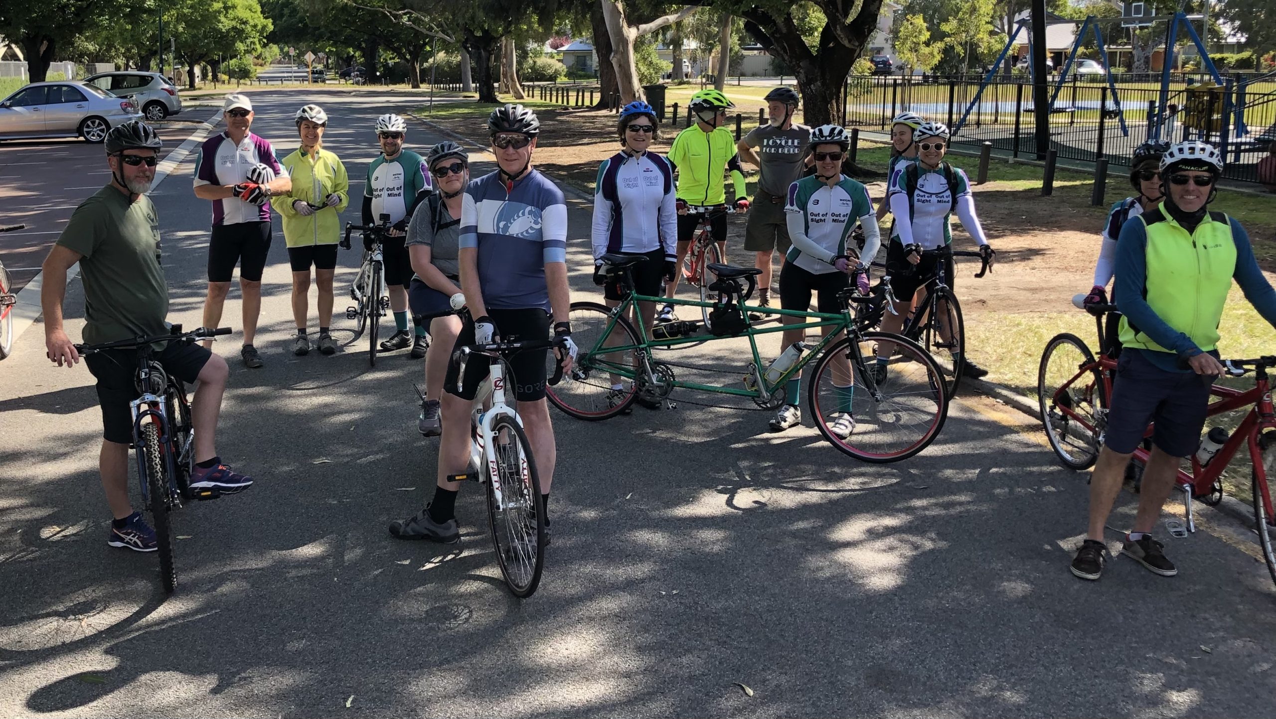Five tandem cyclists, including 4 vision-impaired stokers, plus a number of single cyclists are gathered together on a side road in Lathlain before departing on the 25km ride around southern suburbs, along bike paths and quiet streets.